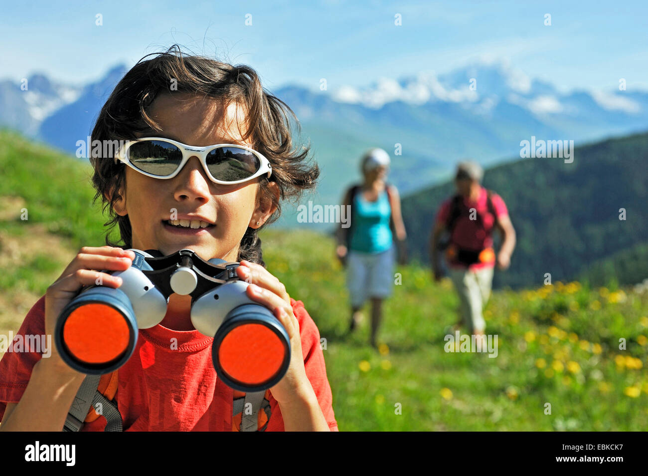 boy holding a spyglass in the hands, France, Savoie Stock Photo