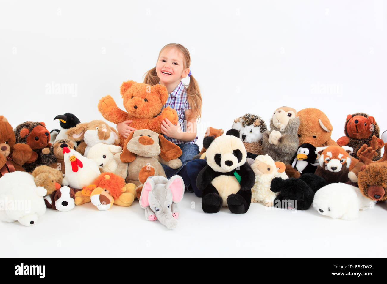 little happy girl playing with soft toys Stock Photo - Alamy