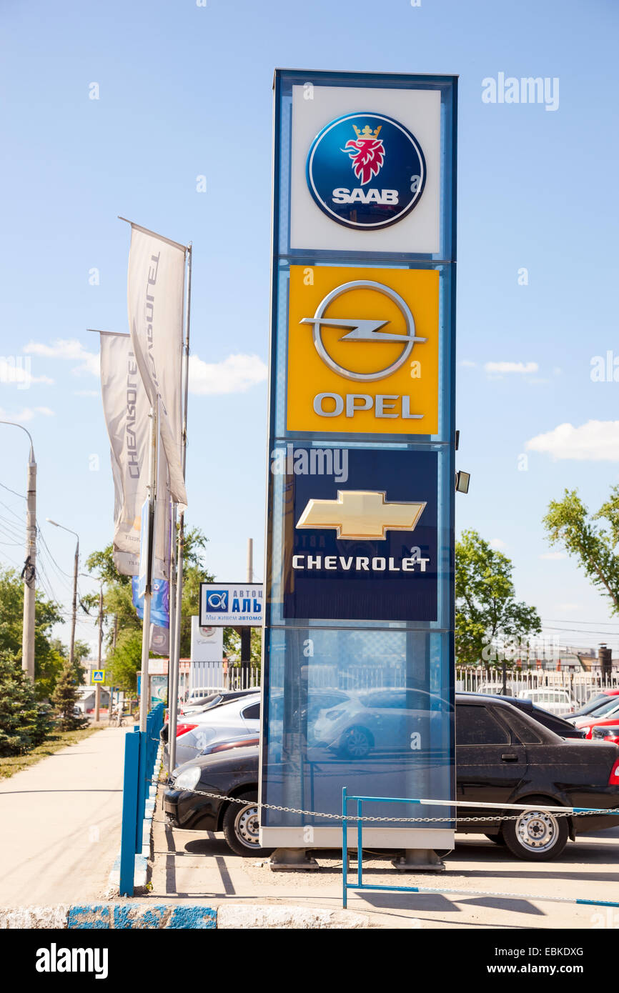 Official dealership signs and flags against blue sky Stock Photo Alamy