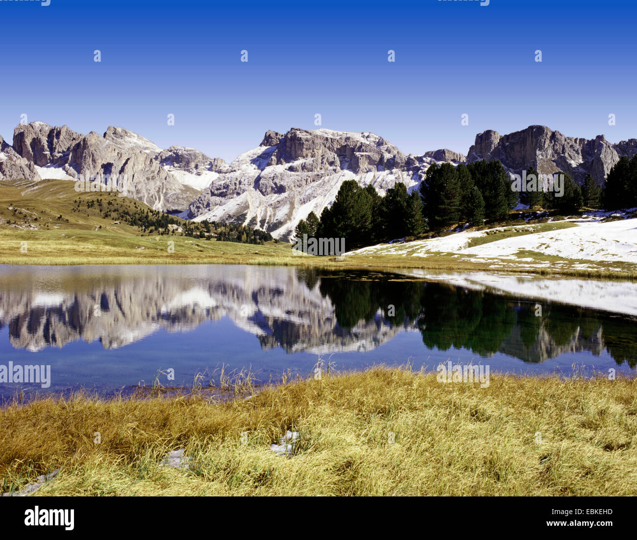 Geisler group reflecting in mountain lake, Italy, South Tyrol, Dolomites Stock Photo