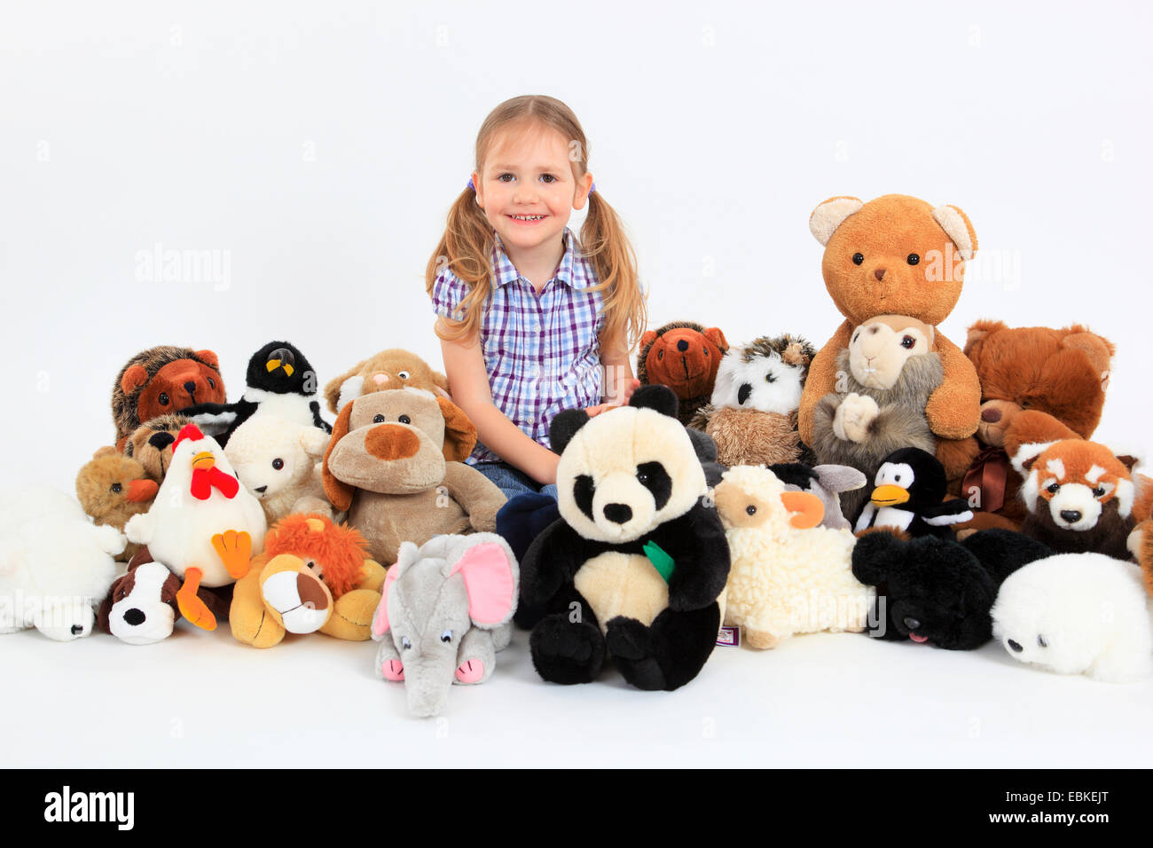 little happy girl playing with soft toys Stock Photo