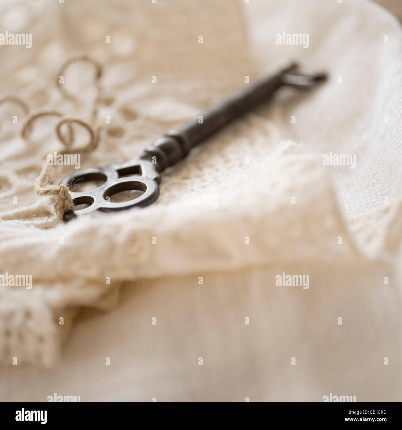 Studio shot of antique key on lace cloth Stock Photo