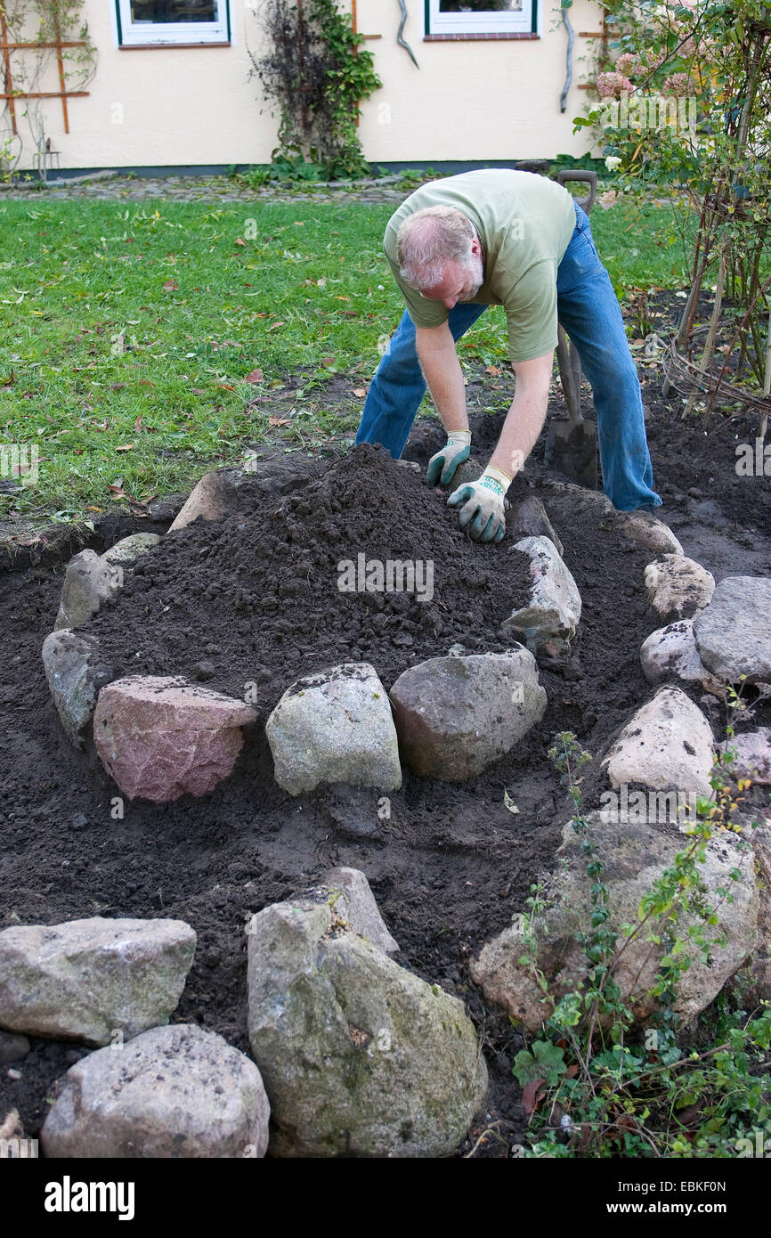 building a rockery for herbs in the garden, Germany Stock Photo