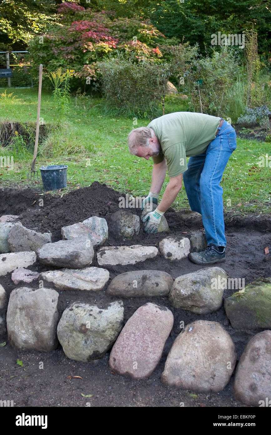 building a rockery for herbs in the garden, Germany Stock Photo