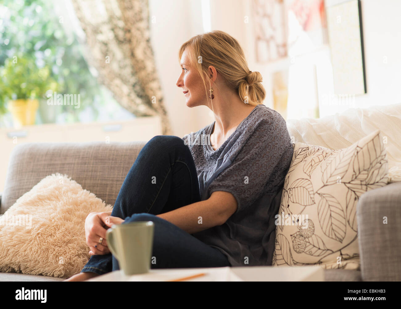 Woman on sofa in living hi-res stock photography and images - Alamy