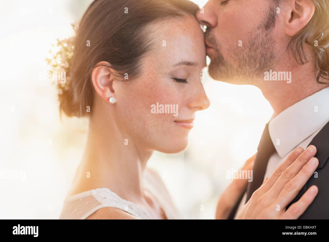 Groom kissing bride Stock Photo
