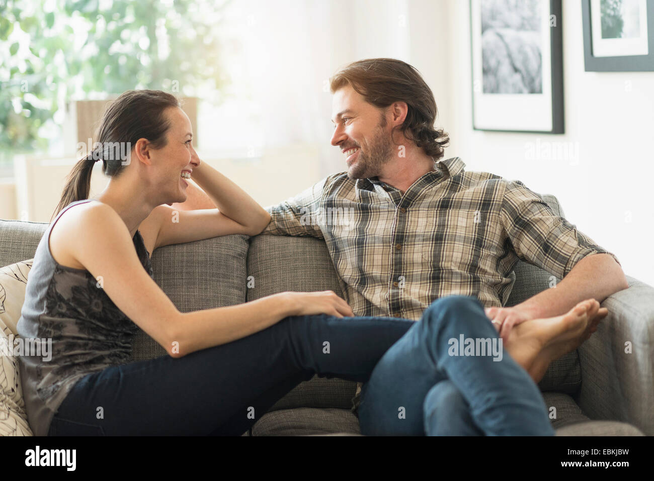 Cheerful couple relaxing on sofa Stock Photo
