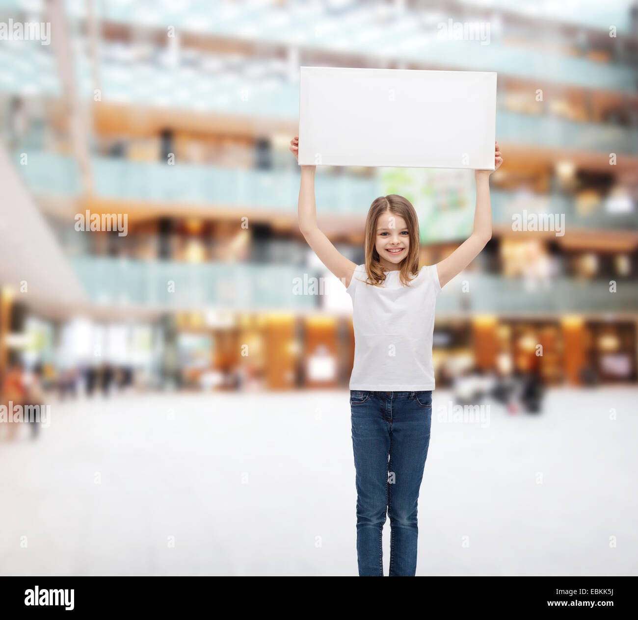 smiling little girl holding blank white board Stock Photo - Alamy