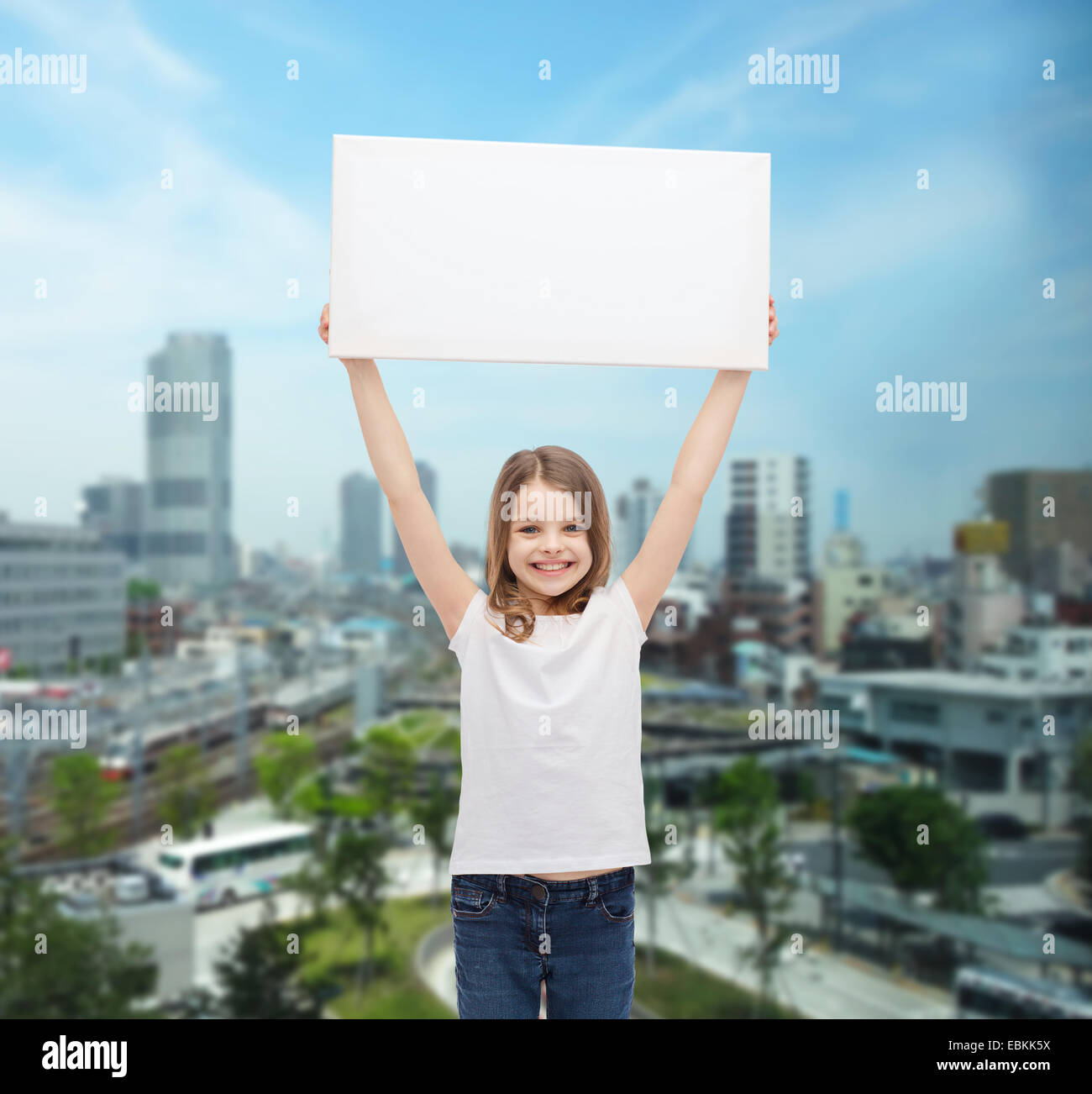 smiling little girl holding blank white board Stock Photo - Alamy