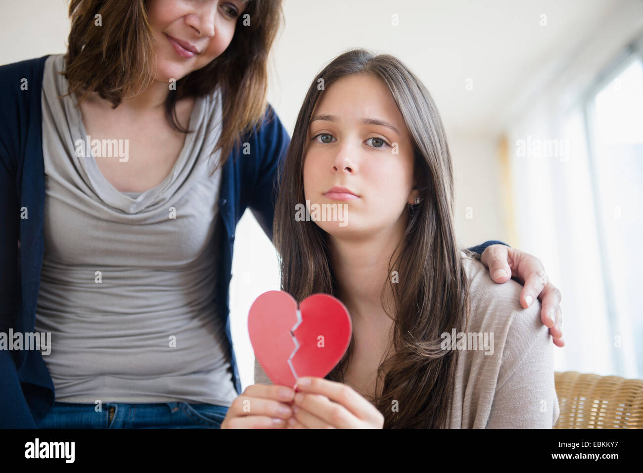 Mom comforting her heartbroken teenage daughter (14-15) Stock Photo