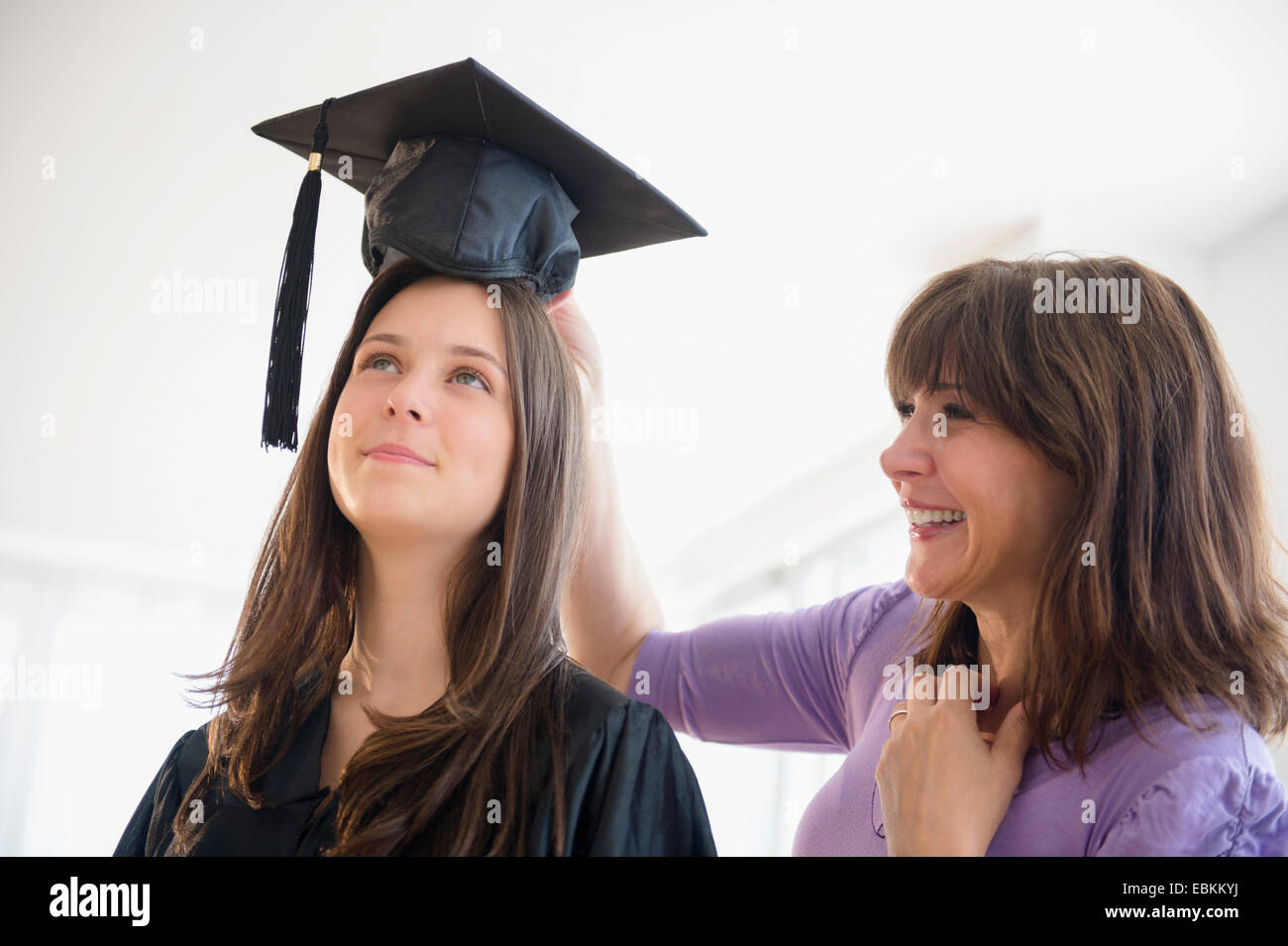 Teenage girl (14-15) getting ready for graduation ceremony Stock Photo