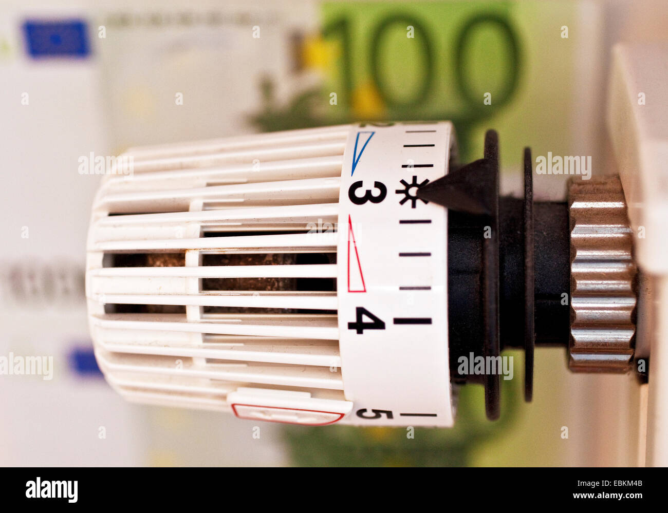 radiator thermostat and bank notes, symbol picture for heating costs, Germany Stock Photo