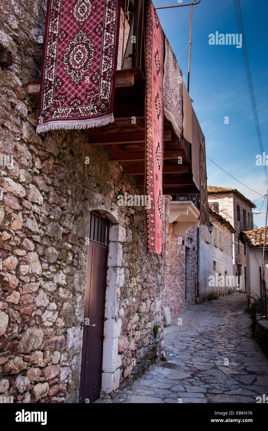Carpets on a balcony over an alley. Dimitsana town, Arcadia, Peloponnese, Greece Stock Photo
