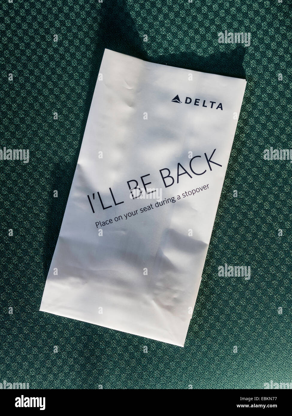 Delta Airlines Occupied Seat Marker, 'I'll Be Back' on Airplane Seat , USA Stock Photo