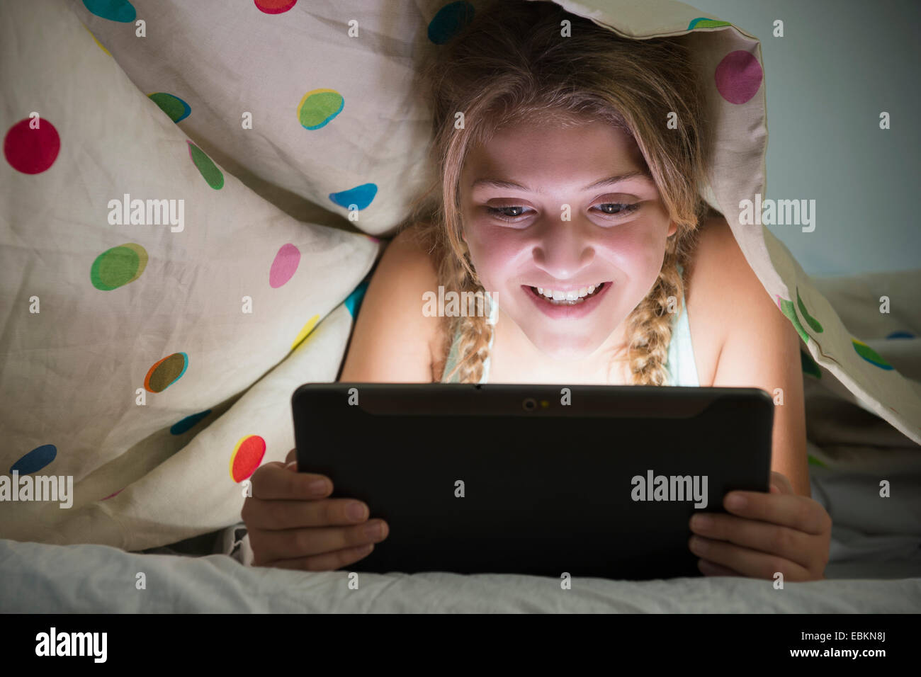Girl (1213) using tablet in bed Stock Photo Alamy