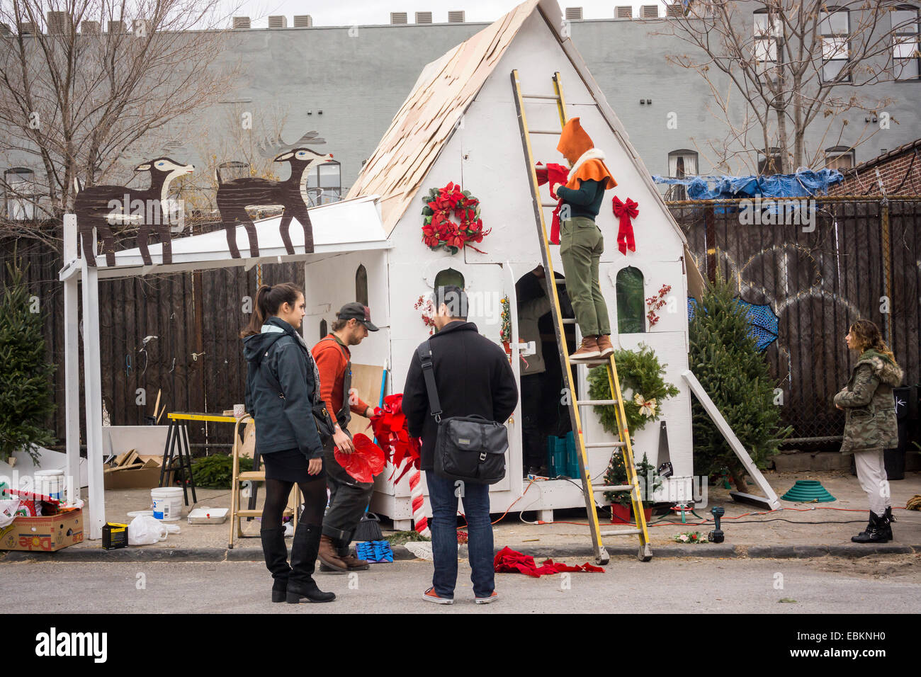 Hipster Christmas tree sellers work on their structure in the Bushwick neighborhood in Brooklyn