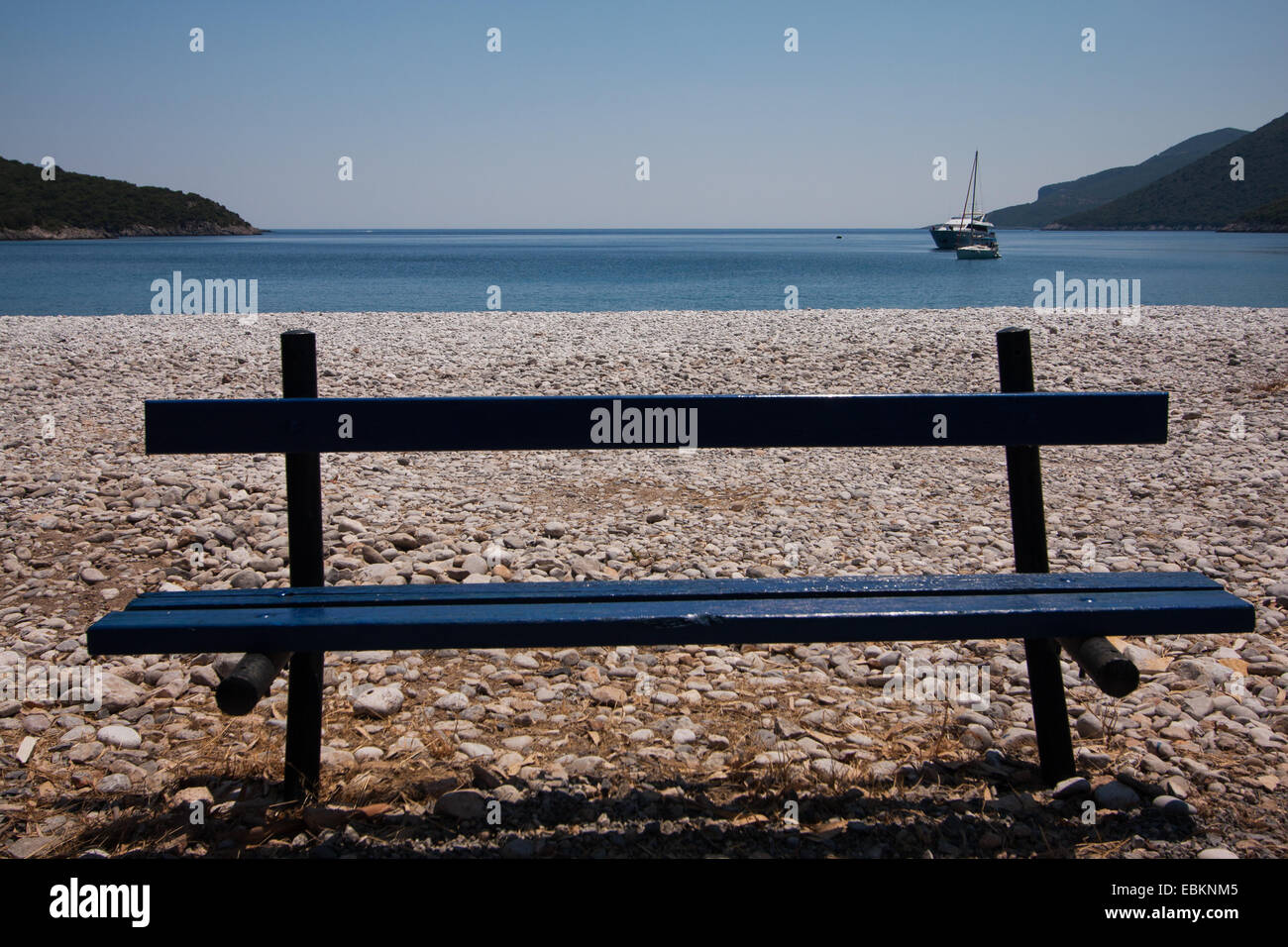 Bench on Fokianos pebble beach. Arcadia, Peloponnese, Greece Stock Photo