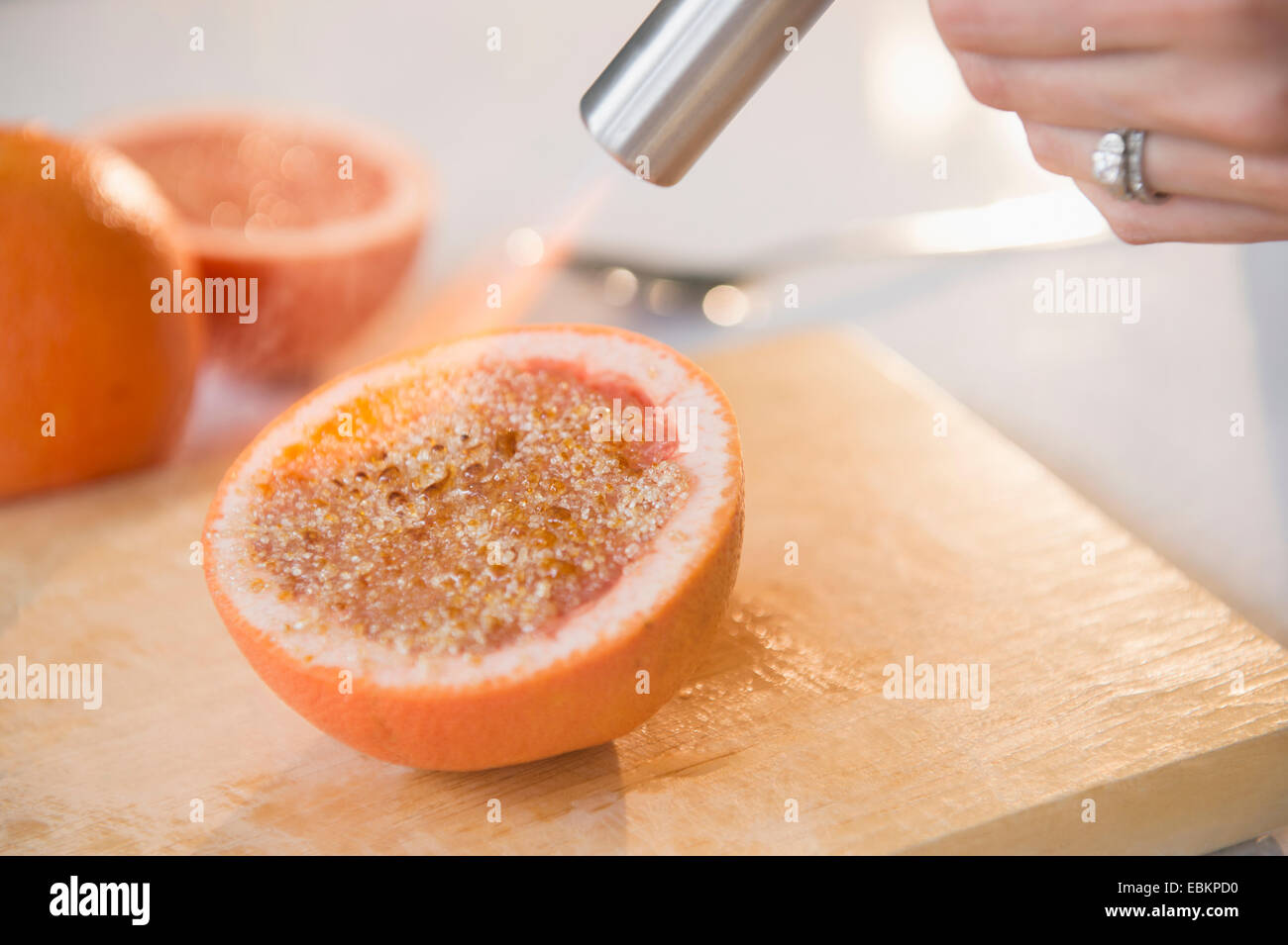 Studio shot of caramelizing sugar on grapefruit slice Stock Photo