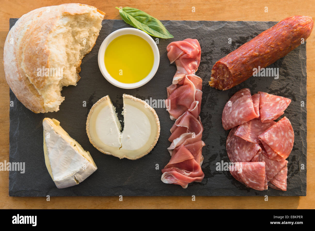 Studio shot of cheese, meat and bread on pate Stock Photo