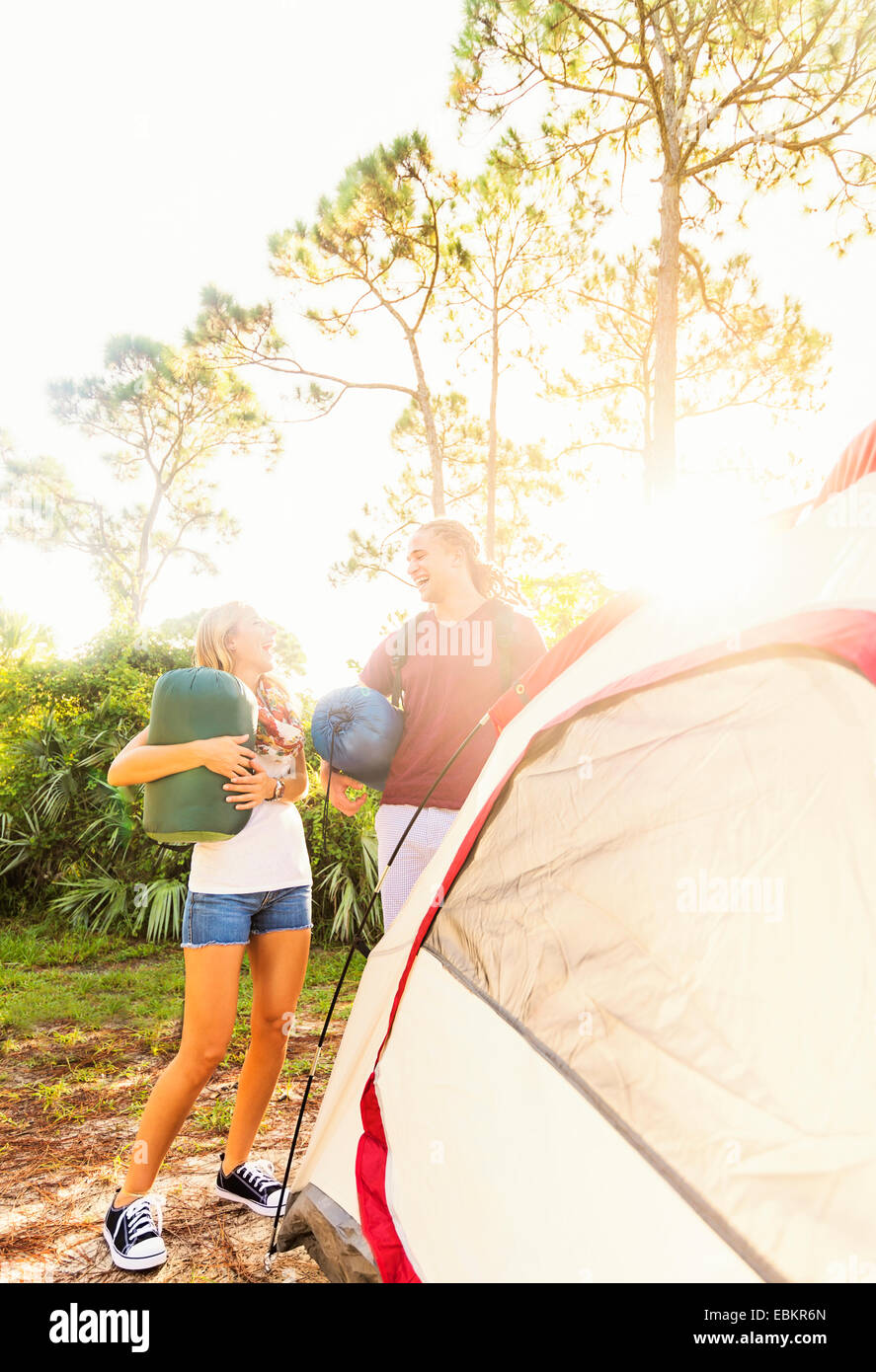 USA, Florida, Tequesta, Couple standing next to tent in forest Stock Photo