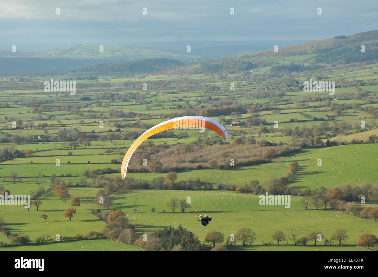 A  paraglider flies over South Shropshire. Stock Photo