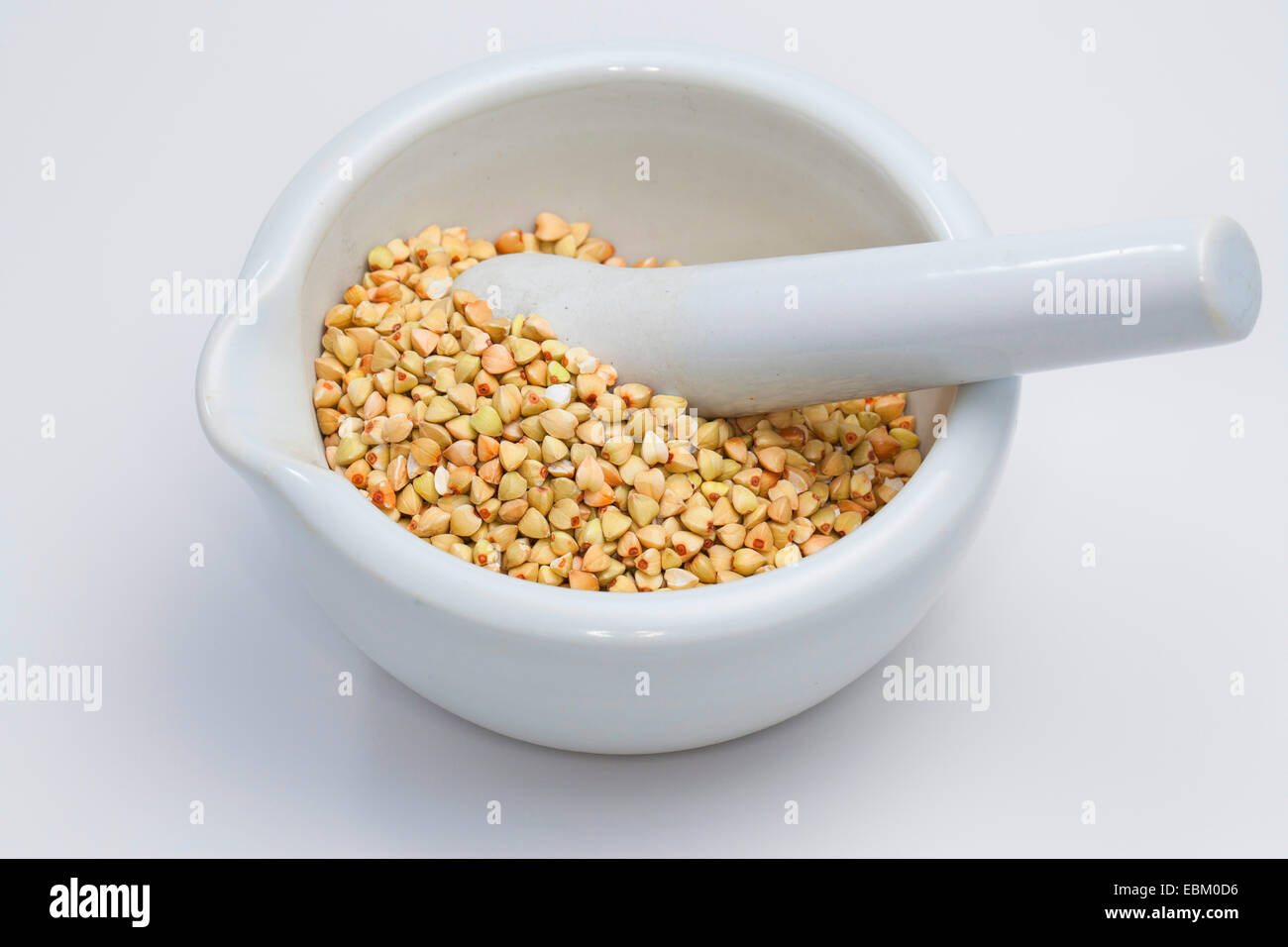 buckwheat (Fagopyrum esculentum), seeds in a mortar with pestle Stock Photo