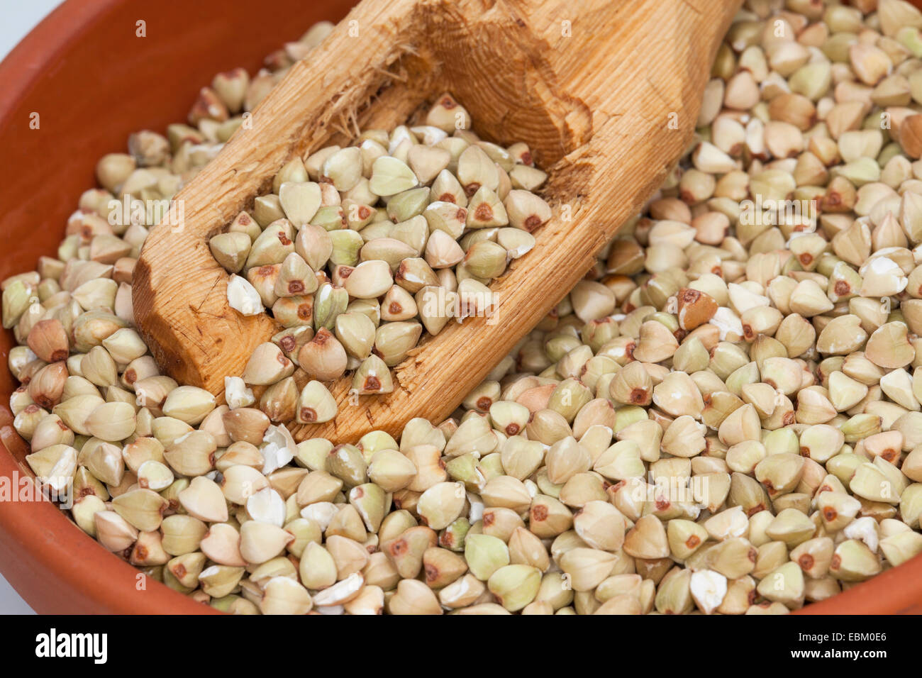 buckwheat (Fagopyrum esculentum), seeds in dish with a wooden spoon Stock Photo