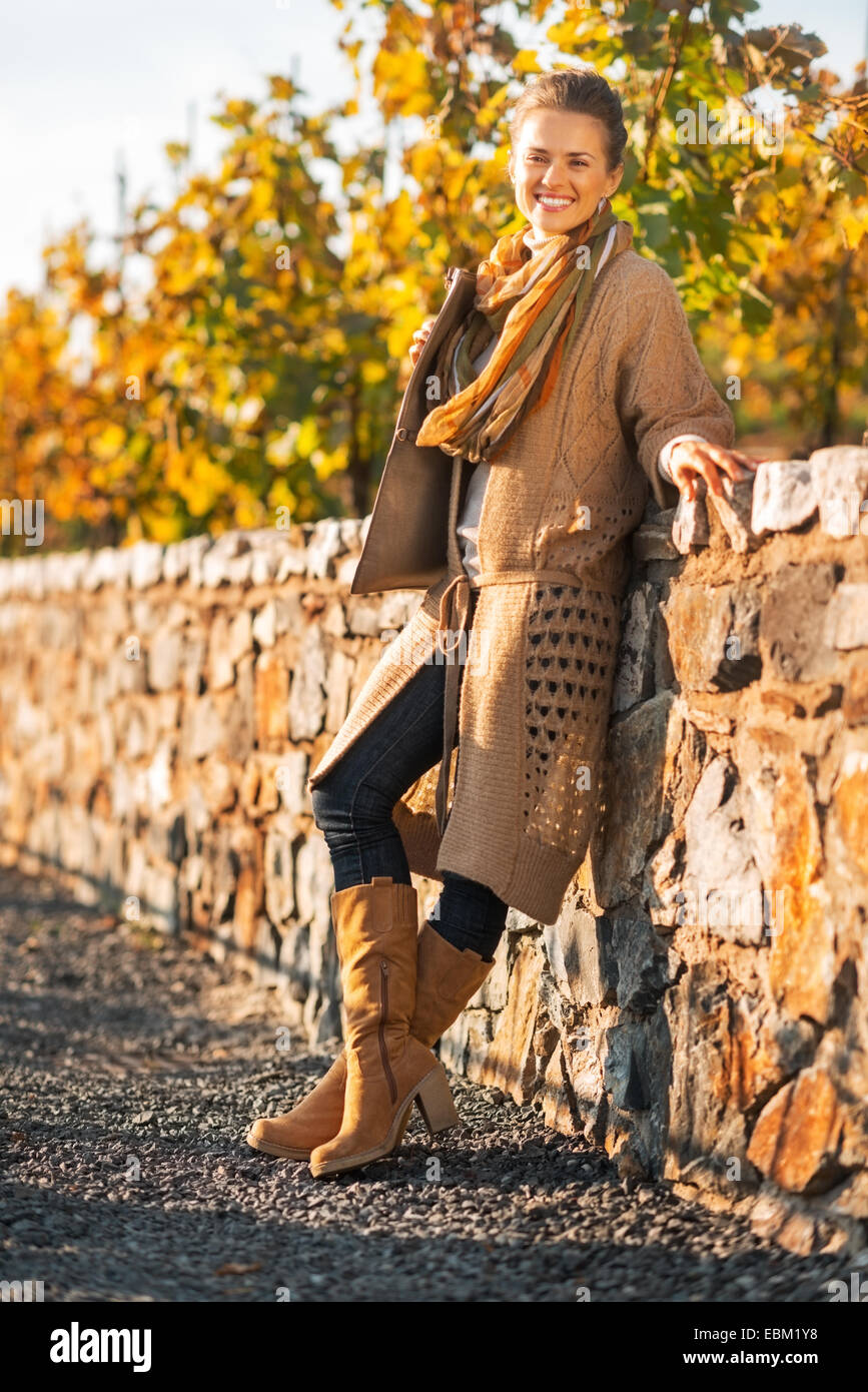 Full length portrait of smiling young woman in autumn park Stock Photo ...