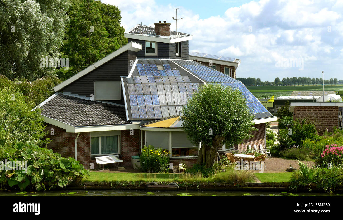luxurious house with solar roofing at an inland waterway, Netherlands Stock Photo