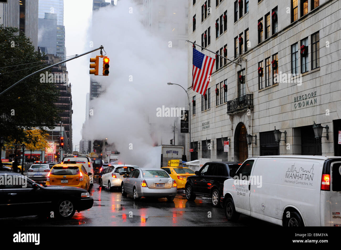 Manhattan New York USA November 2014  - Steam rises from a subway in the pouring rain by Fifth Avenue Stock Photo