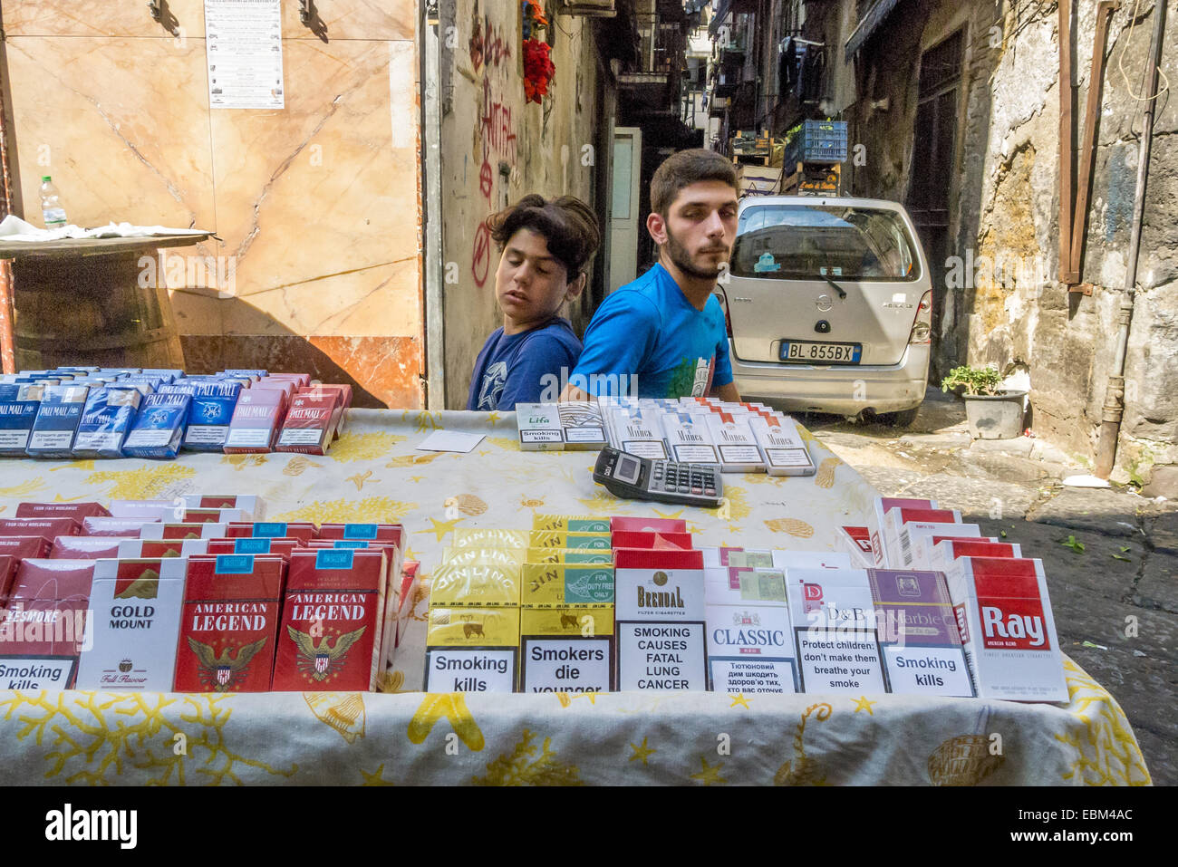 Two boys selling untaxed cigarettes on the streets of Naples. Stock Photo