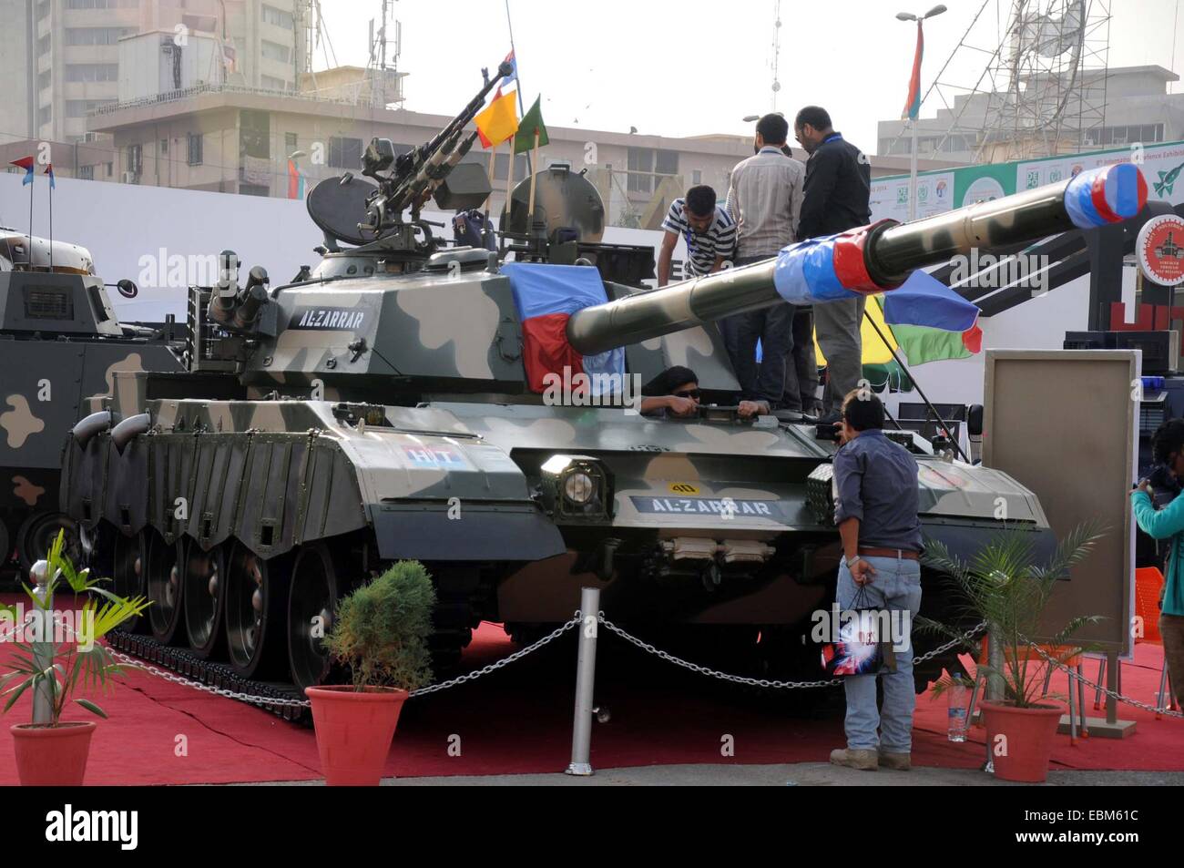Karachi. 2nd Dec, 2014. Visitors look at an Al-Arrar battle tank during the International Defence Exhibition and Seminars in southern Pakistani port city of Karachi on Dec. 2, 2014. Some 333 exhibitors including 77 Pakistani companies exhibited their products during the exhibition. Credit:  Masroor/Xinhua/Alamy Live News Stock Photo