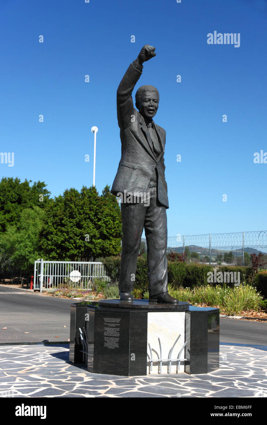 A statue of Nelson Mandela with his right arm raised in a black power salute. Stock Photo