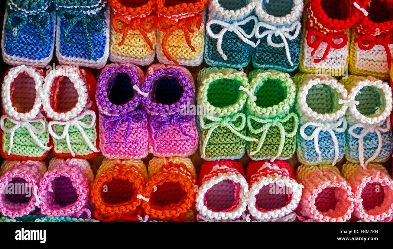 Knitted booties for newborns, from colored wool and exposed to sale. Stock Photo