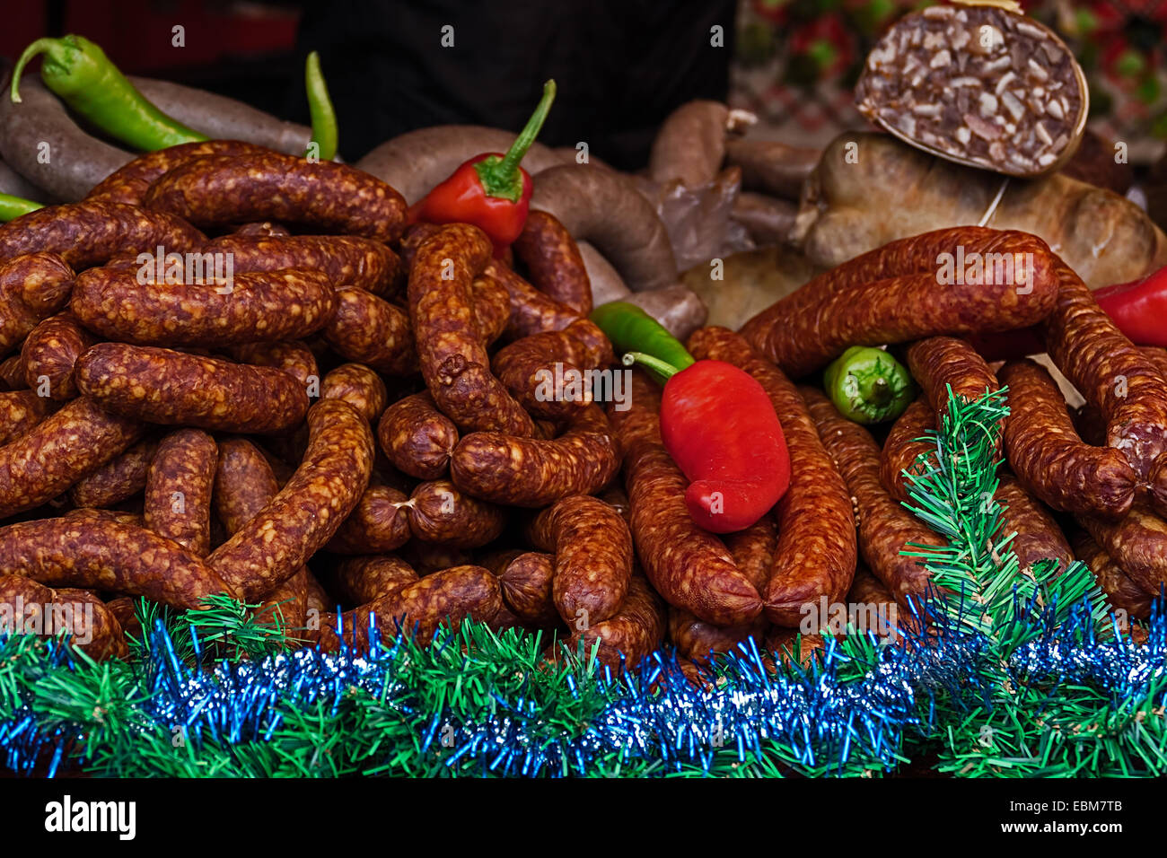 Various smoked sausages specialties, placed on a table and exposed on sale. Specific for December. Stock Photo