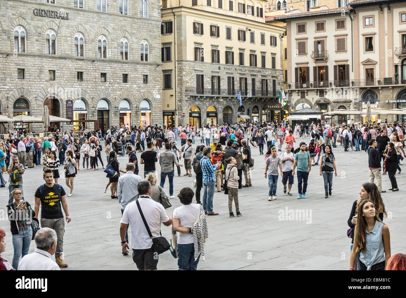view looking northwest across historic Piazza della Signoria crowded with pedestrians Florence Italy Stock Photo