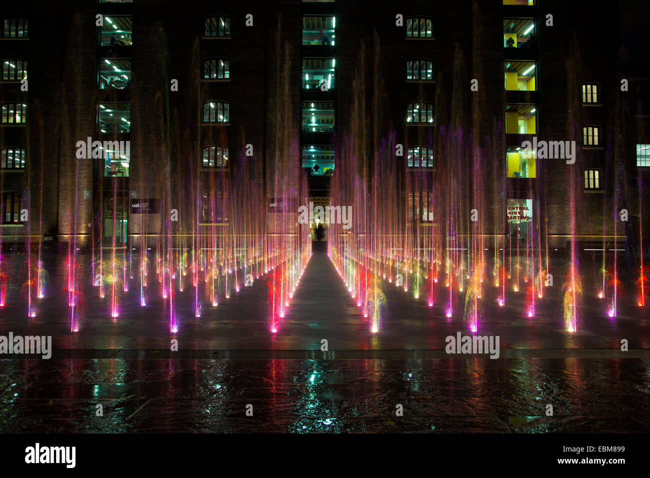 Fountain at night in Granary Square in front of Central Saint Matrins, Kings Cross St Pancras Stock Photo