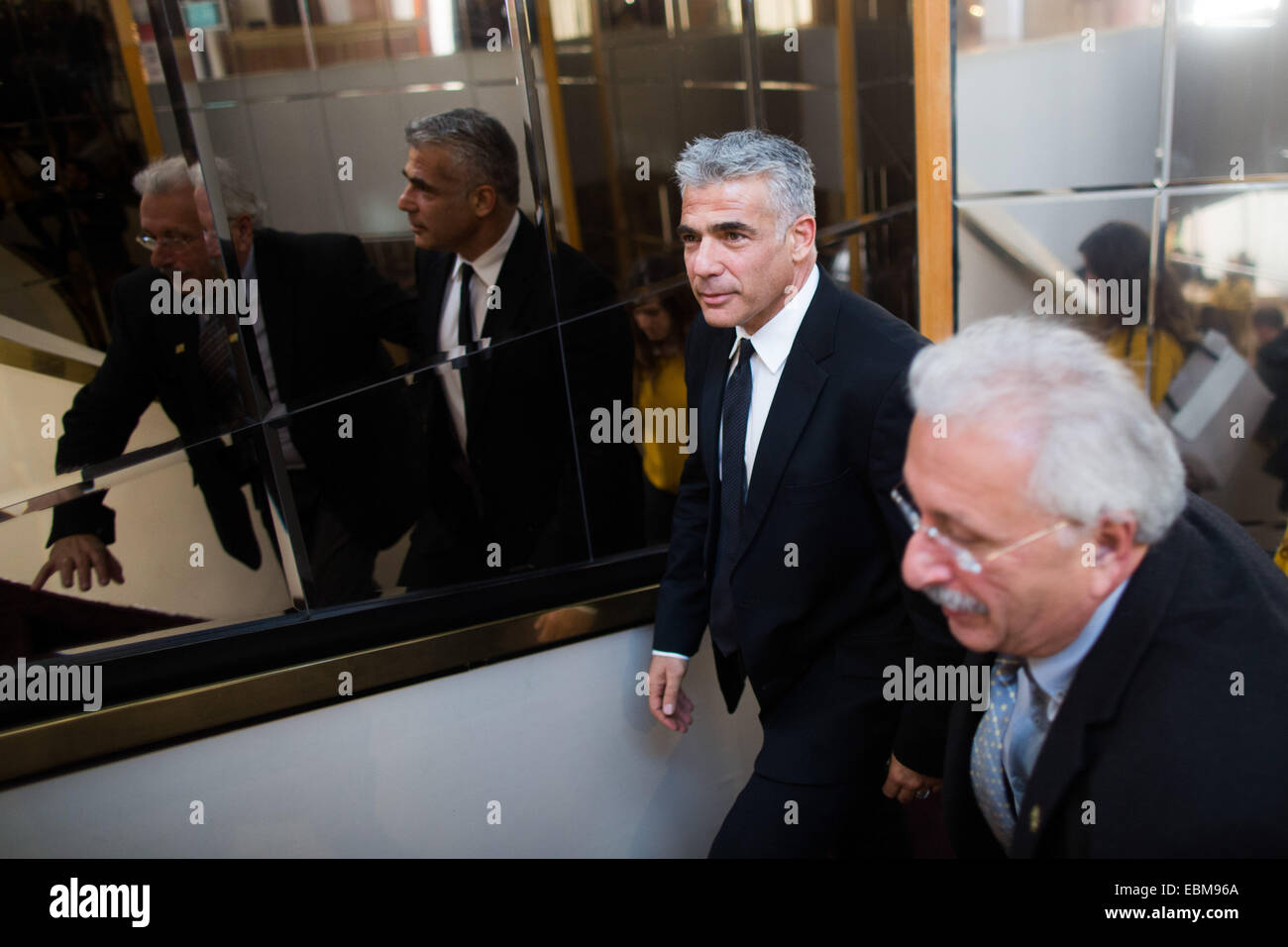 Jerusalem. 2nd Dec, 2014. Israeli Finance Minister Yair Lapid (1st L) leaves a financial conference in Jerusalem, on Dec. 2, 2014. Israeli Prime Minister Benjamin Netanyahu announced his support for dispersing the Knesset (parliament) and conducting early elections amid a coalition crisis. During a press conference at his Jerusalem office, Netanyahu also said he has ordered to fire Justice Minister Tzipi Livni and Finance Minister Yair Lapid, who he said plotted against him by outspokenly criticizing his policies. Credit:  JINI/Xinhua/Alamy Live News Stock Photo