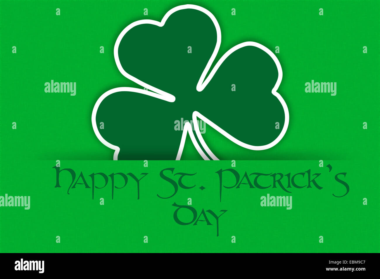 Irish holiday St. Patrick's Day green greeting backdrop with clover and text - Happy St. Patrick's Day Stock Photo