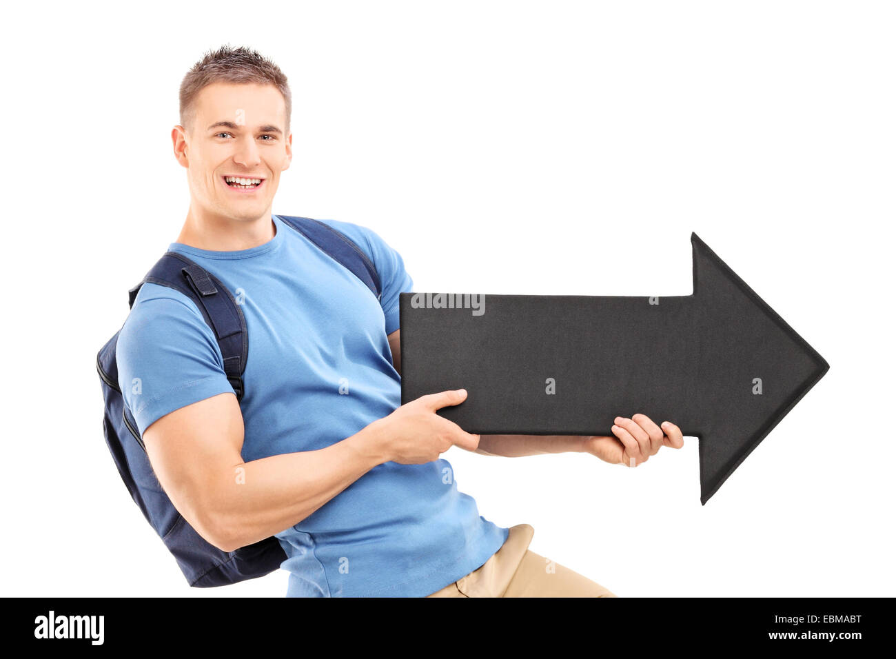 Male student holding a big black arrow pointing right isolated on white ...