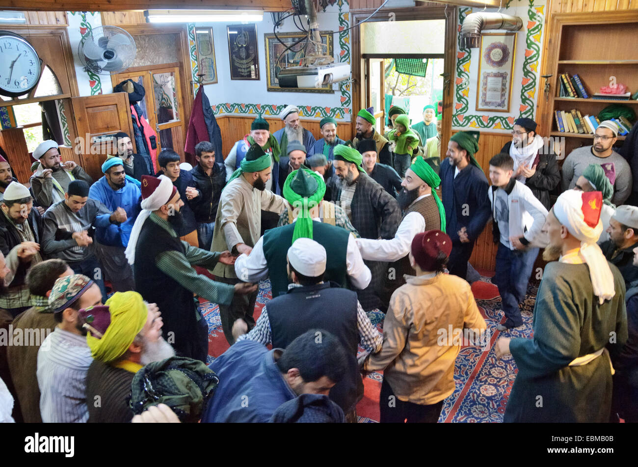 Muslims dancing during zhikr, mystical Sufi prayer, in the mosque inside the residence of Shaikh Nazim Al-Haqqani, leader of the Stock Photo