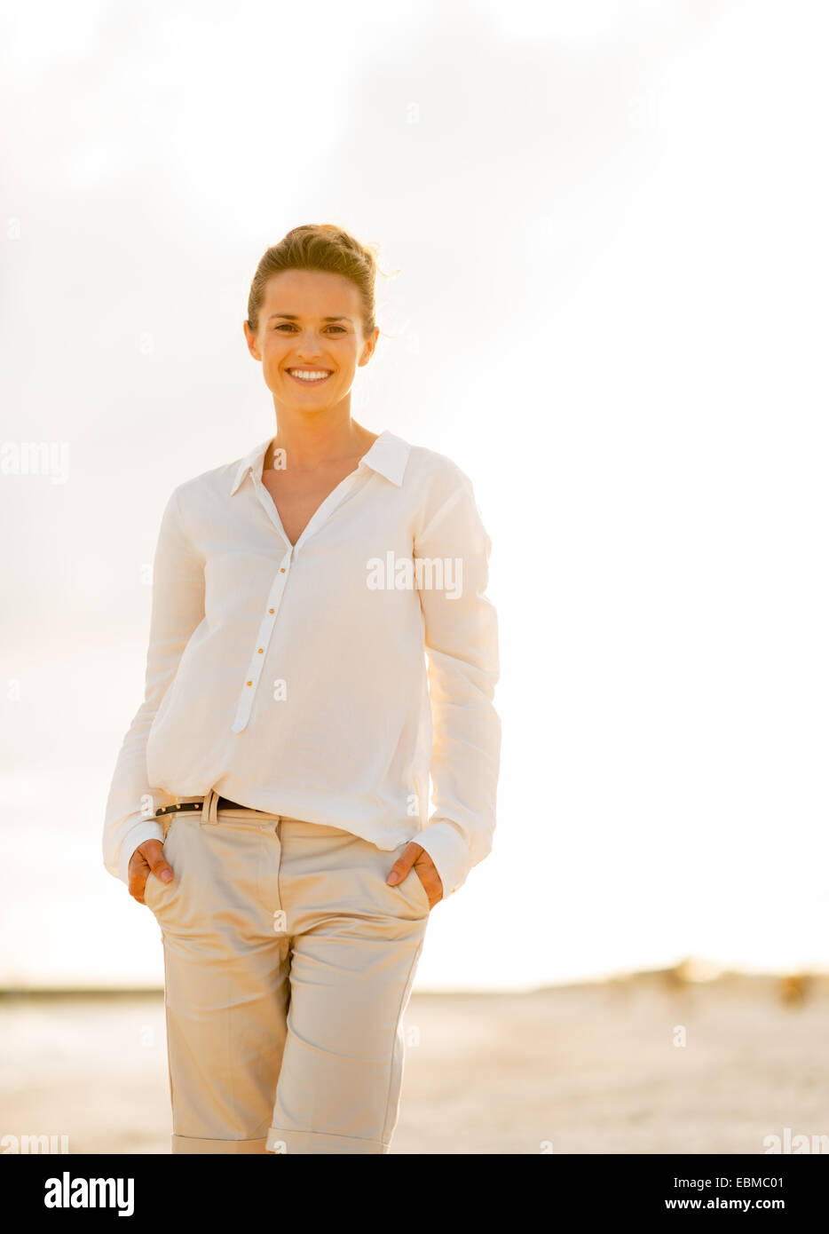 Portrait of happy young woman on beach at the evening Stock Photo - Alamy