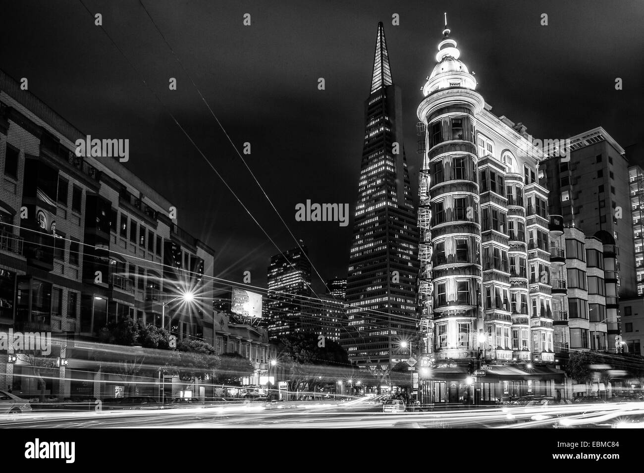 Buildings lit up at night in a city, Columbus Tower, Transamerica Pyramid, San Francisco, California, USA Stock Photo