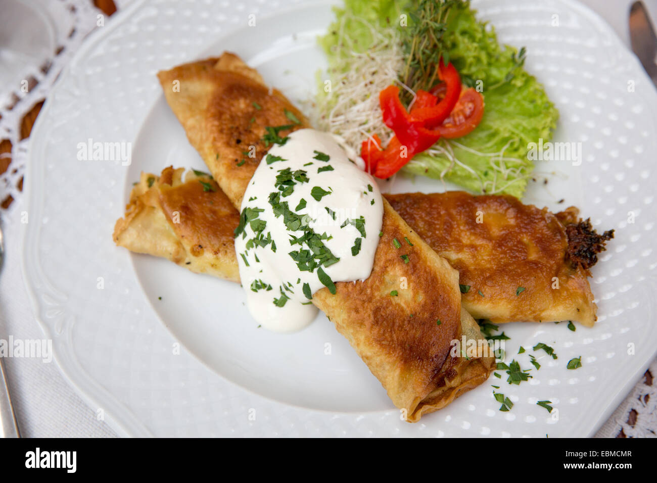 Krakow, Poland; Polish food, spinach pancakes with garlic sauce Stock