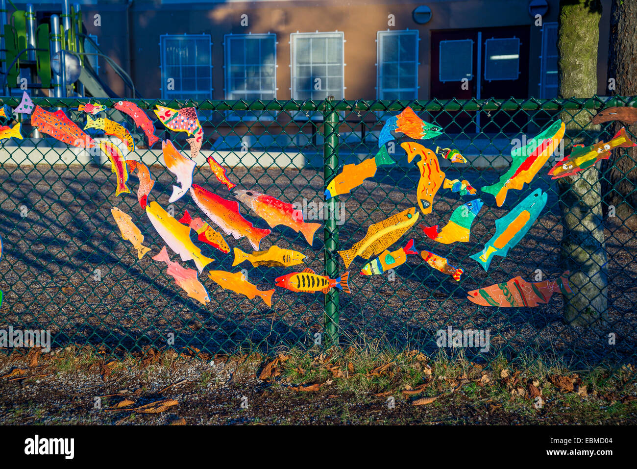 Stream of dreams, salmon art on fence, Hastings School, Vancouver, British Columbia, Canada Stock Photo