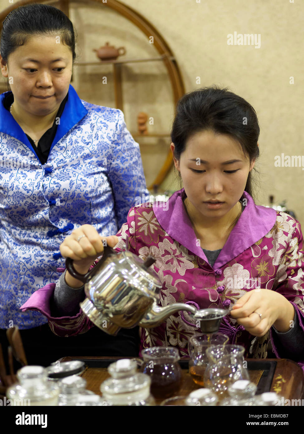 Young woman pouring tea during a traditional chinese tea ceremony Stock Photo