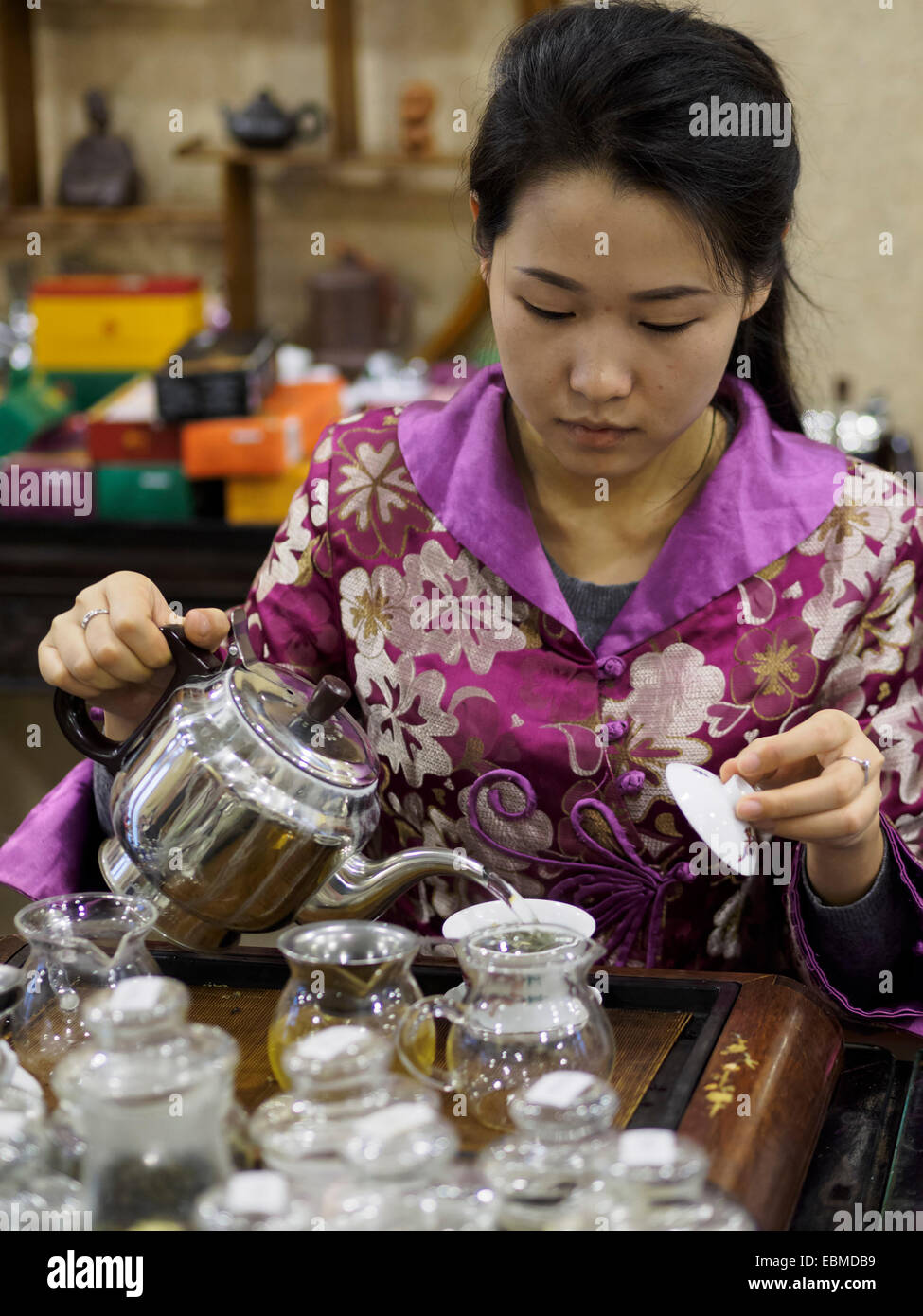 Young woman pouring tea during a traditional chinese tea ceremony Stock Photo