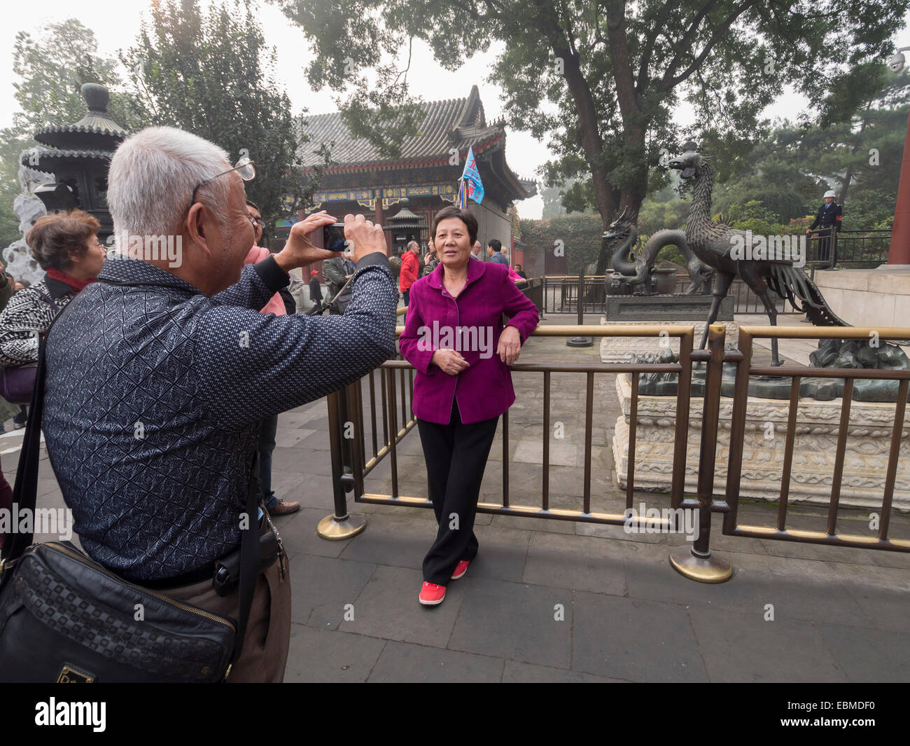 Chinese tourist taking photo of another tourist at The Summer Palace in Beijing, China, Asia Stock Photo