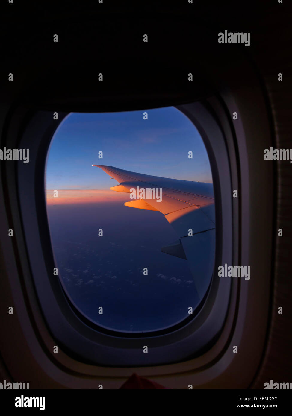 View of airplane wing from inside the aircraft's window Stock Photo