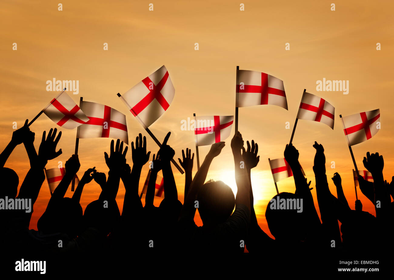 Silhouettes of People Holding Flag of England Stock Photo